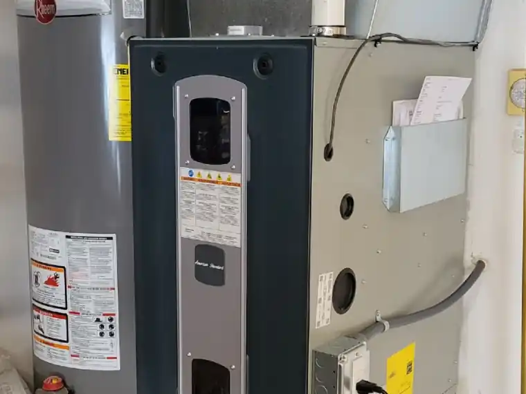A new high-efficiency furnace installed beside the water heater in a Yakima utility room