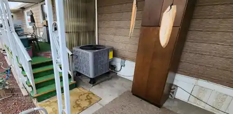 New condenser beside porch steps