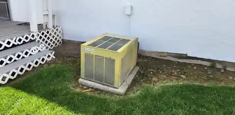 Old yellowed outdoor unit that was replaced