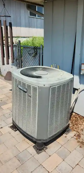 Old condenser on pavers before replacement