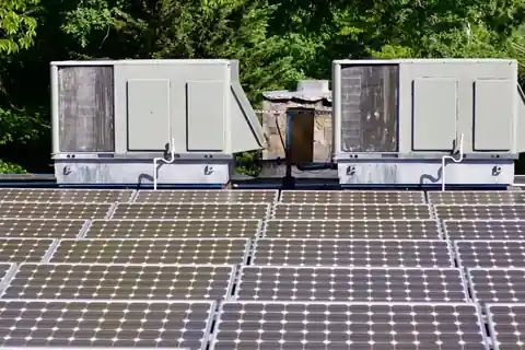 Two rooftop units on a roof covered in solar panels